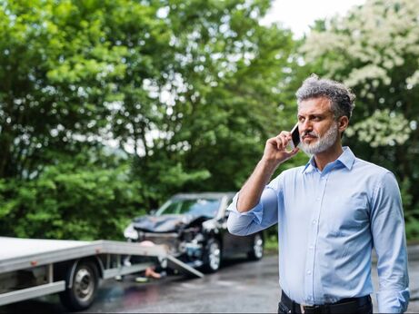 Man on the phone who is involved in a car accident. 